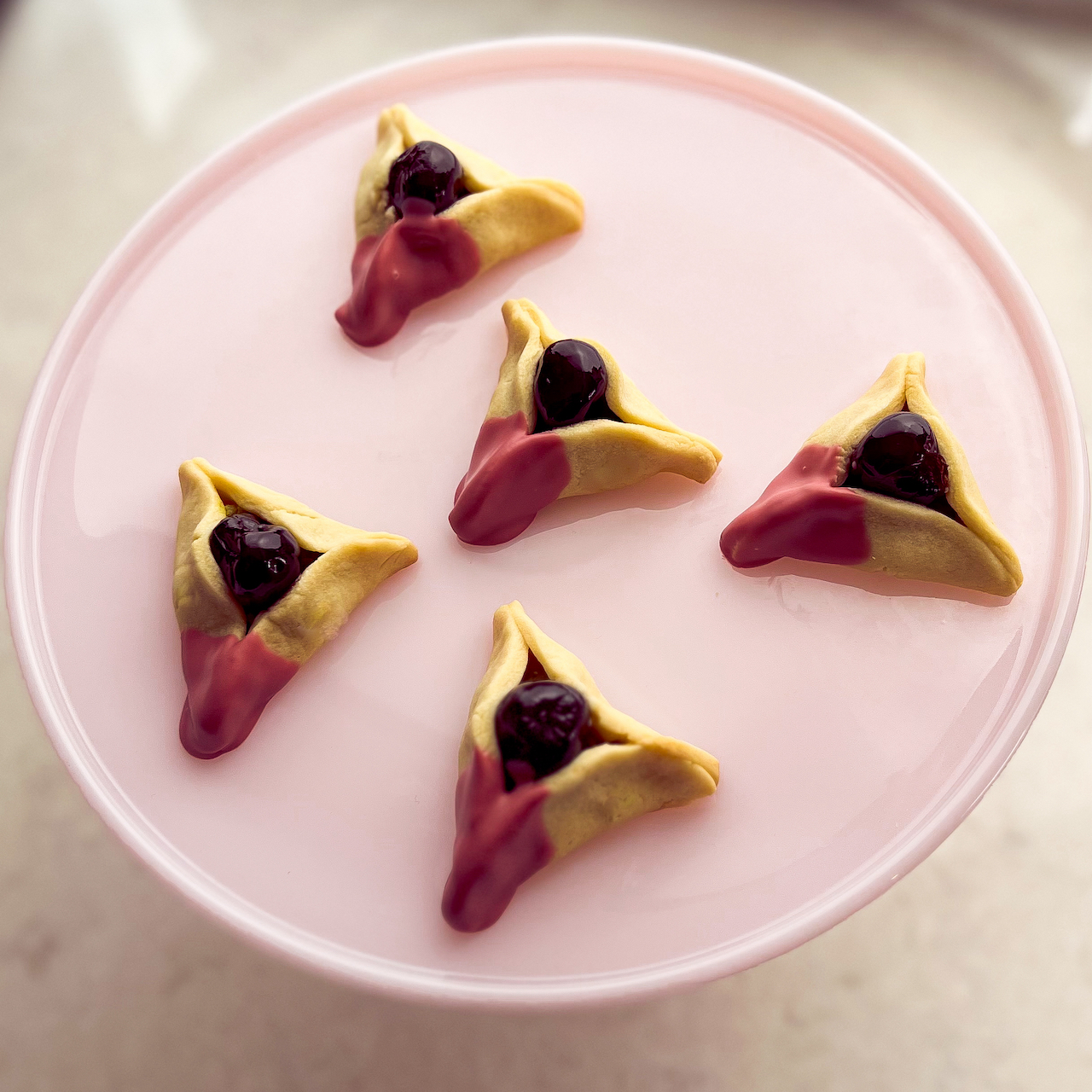 https://veredguttman.com/wp-content/uploads/2023/03/Amarena-cherry-and-marzipan-hamantaschen-1.jpg